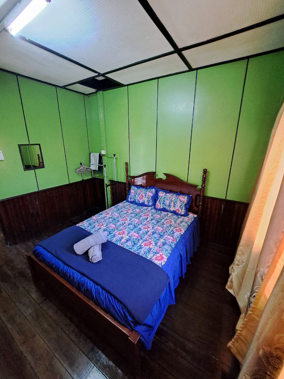 Queen bed, air conditioning, wardrobe space, hangers and towels prepared for guests